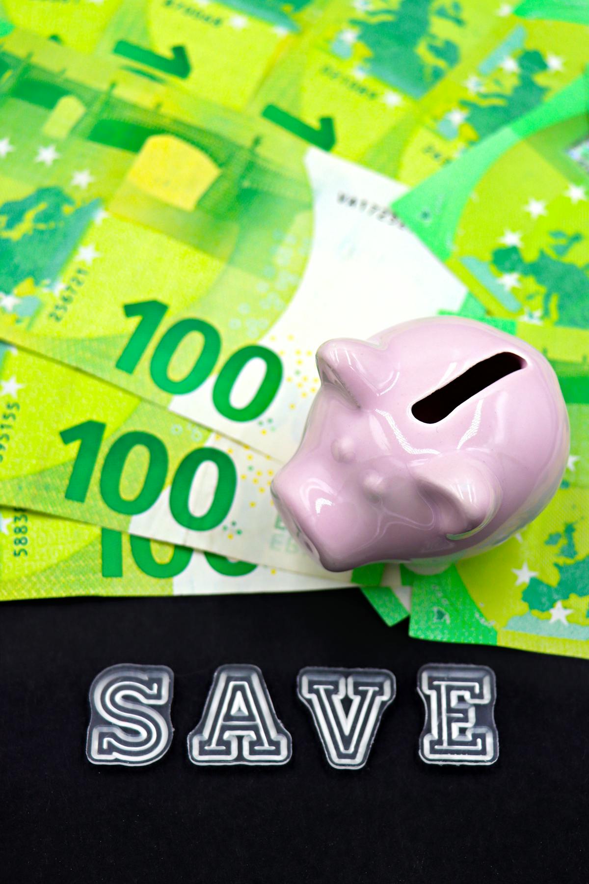 Glass jar filled with coins and cash representing retirement savings after a pay raise